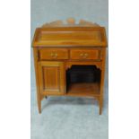 An Edwardian mahogany and inlaid bureau with fall front enclosing fitted interior above an