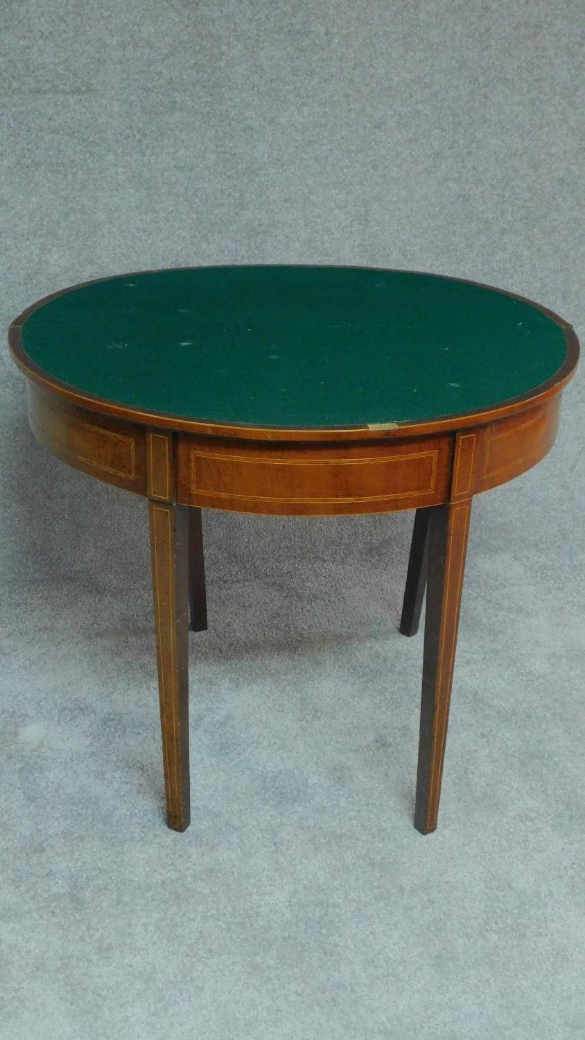 A Georgian mahogany and boxwood strung demi lune card table on square tapering supports. H.74 W.91 - Image 2 of 5