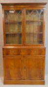 A Georgian style mahogany library bookcase, the upper glazed section above base fitted with