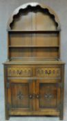 A Jacobean style carved oak sideboard with arched plate rack. H.178 W.92 D.43cm