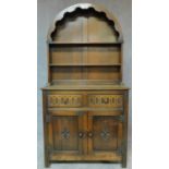 A Jacobean style carved oak sideboard with arched plate rack. H.178 W.92 D.43cm