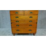 An early 19th century teak brass bound two section military campaign chest with brass inset