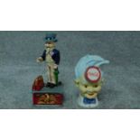 A painted metal Uncle Sam money box and another similar advertising Coca Cola. H.28cm