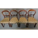 A set of four Victorian mahogany balloon backed dining chairs with floral tapestry style stuffover