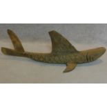 A carved wooden figure of a flying fish. W.120cm