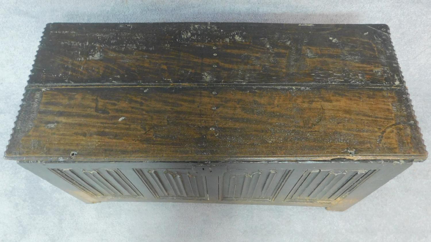 An early 17th century oak coffer with linenfold panels and hinged lidded top on block feet. H.62 W. - Image 8 of 10