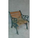 A wrought iron and teak slatted Coalbrookdale style garden bench. H.77cm