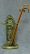 A cast metal Colebrookdale style hall stand and a collection of walking sticks. H.93