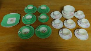 A green floral decorated tea set for six and a seven piece pink floral tea set.