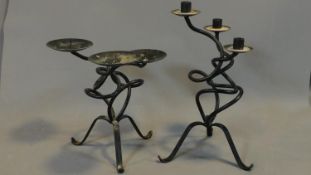 A pair of shaped iron pricket candlesticks. H.31 (tallest)