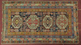 A Turkish rug with 4 pendant medallions surrounded by multiple geometric borders 180x100cm