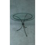 A wrought iron and glass topped conservatory table. H.78 W.92 D.92cm