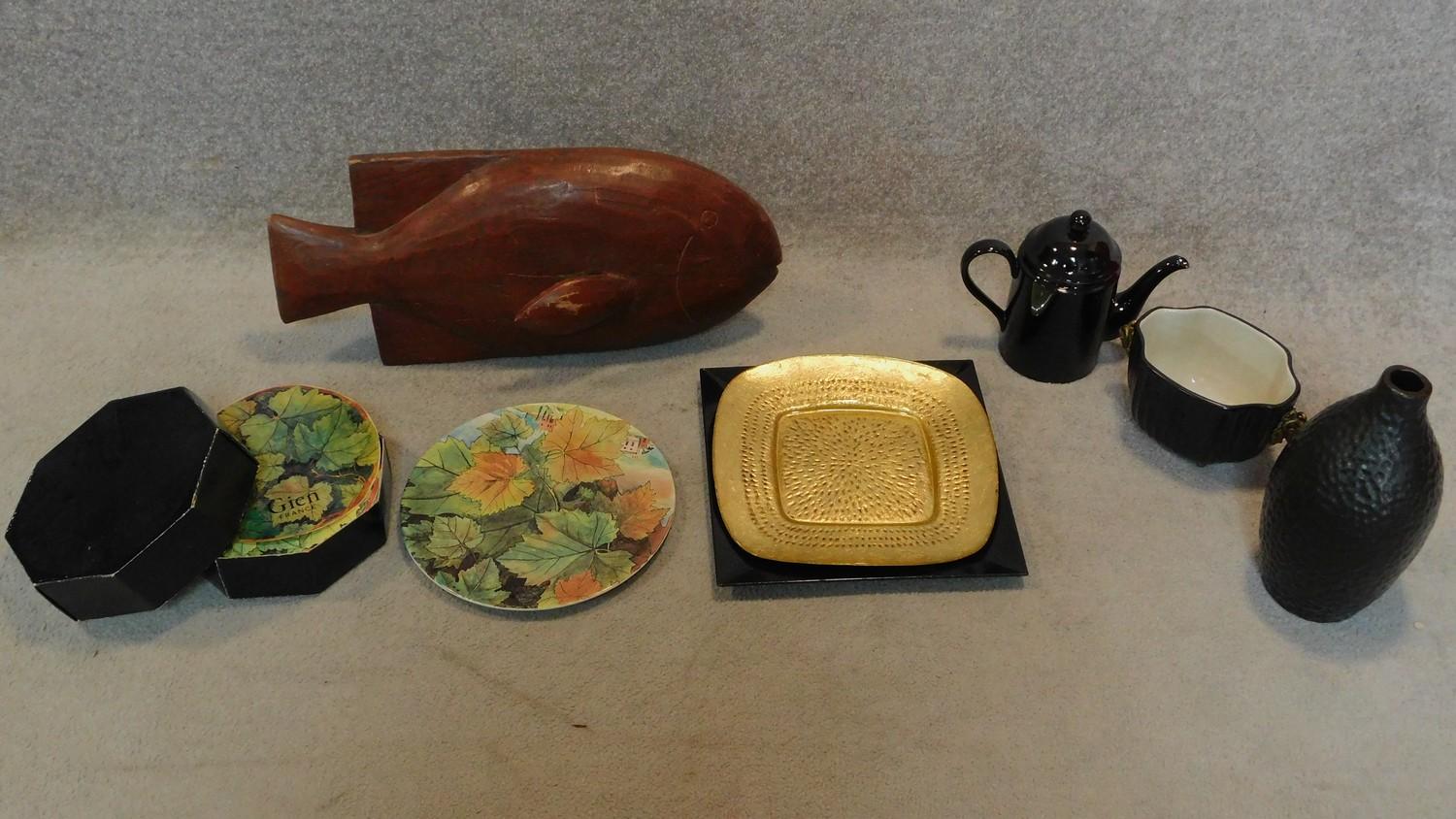 A boxed set of foliate design plates, a tureen with ram's head handles, a carved fish and other