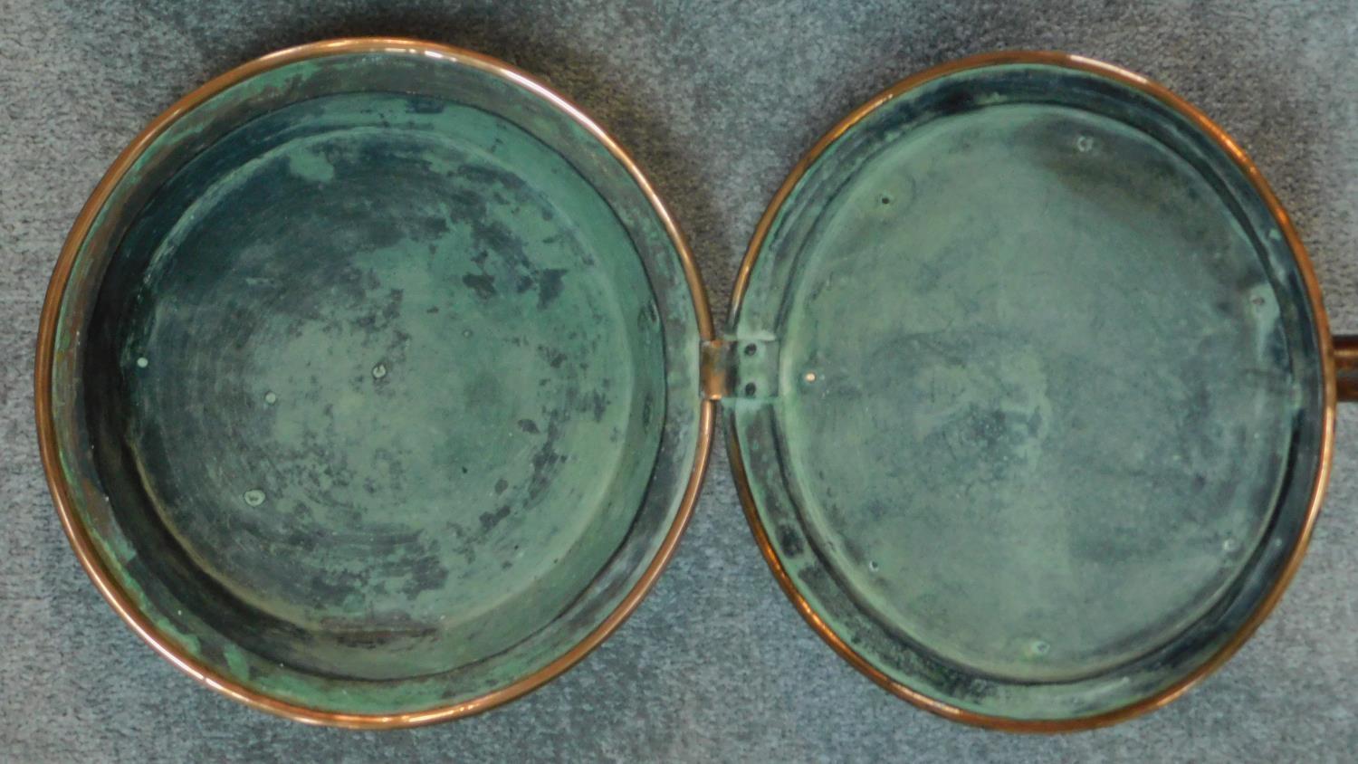 A collection of three 19th century copper warming pans with turned handles. W.116cm. - Image 5 of 6