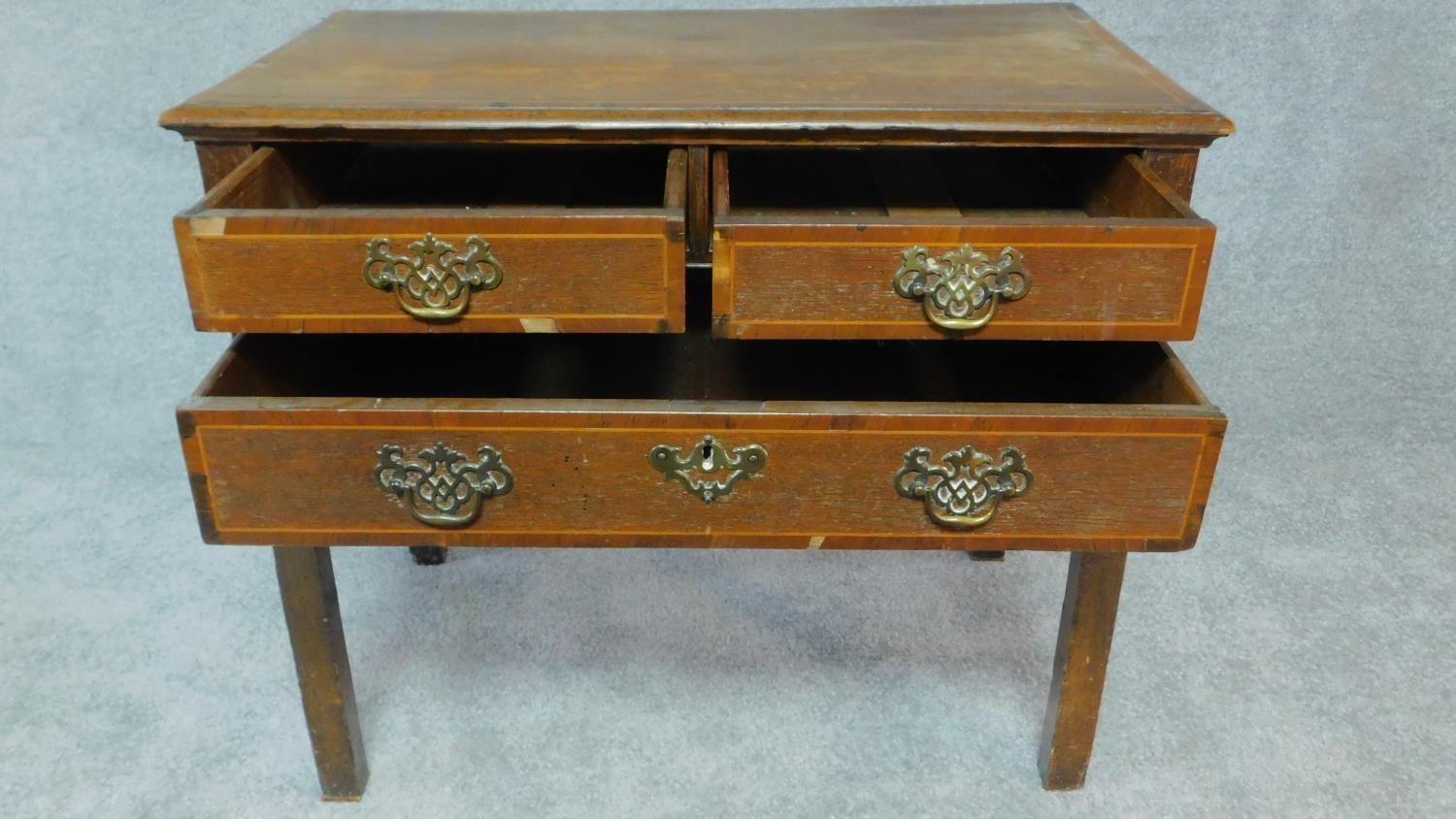 A Georgian country oak lowboy with mahogany crossbanding and satinwood stringing, two short over - Image 3 of 8