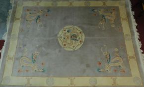 A Chinese rug with central medallion on a mink field with floral spandrels encompassed with a