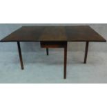 A Georgian mahogany drop flap dining table on square section supports. H.72 W.152 D.111cm