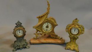 A shaped gilt metal mantel clock on marble base, an Art Nouveau mantel clock and another similar.
