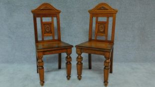 A pair of late Victorian oak hall chairs with walnut crossbanded solid seats. H.97cm