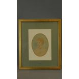 A gilt framed and glazed watercolour sketch of a young child set in oval mount. 43x36cm