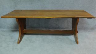 A honey oak refectory dining table with trestle supports. H.76 W.214 H.81cm