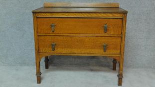 A mid 20th century oak chest of two long drawers. H.81 W.90 D.45cm