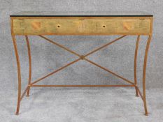 A gilt metal and glass topped console table with gilt and heraldry decorated fascia. H.77 W.102 D.