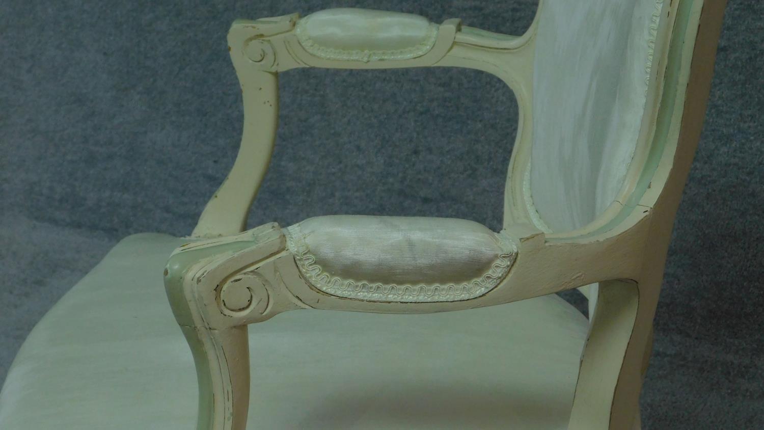 A carved and painted fauteuil in ivory damask on cabriole supports. H.86cm - Image 4 of 9