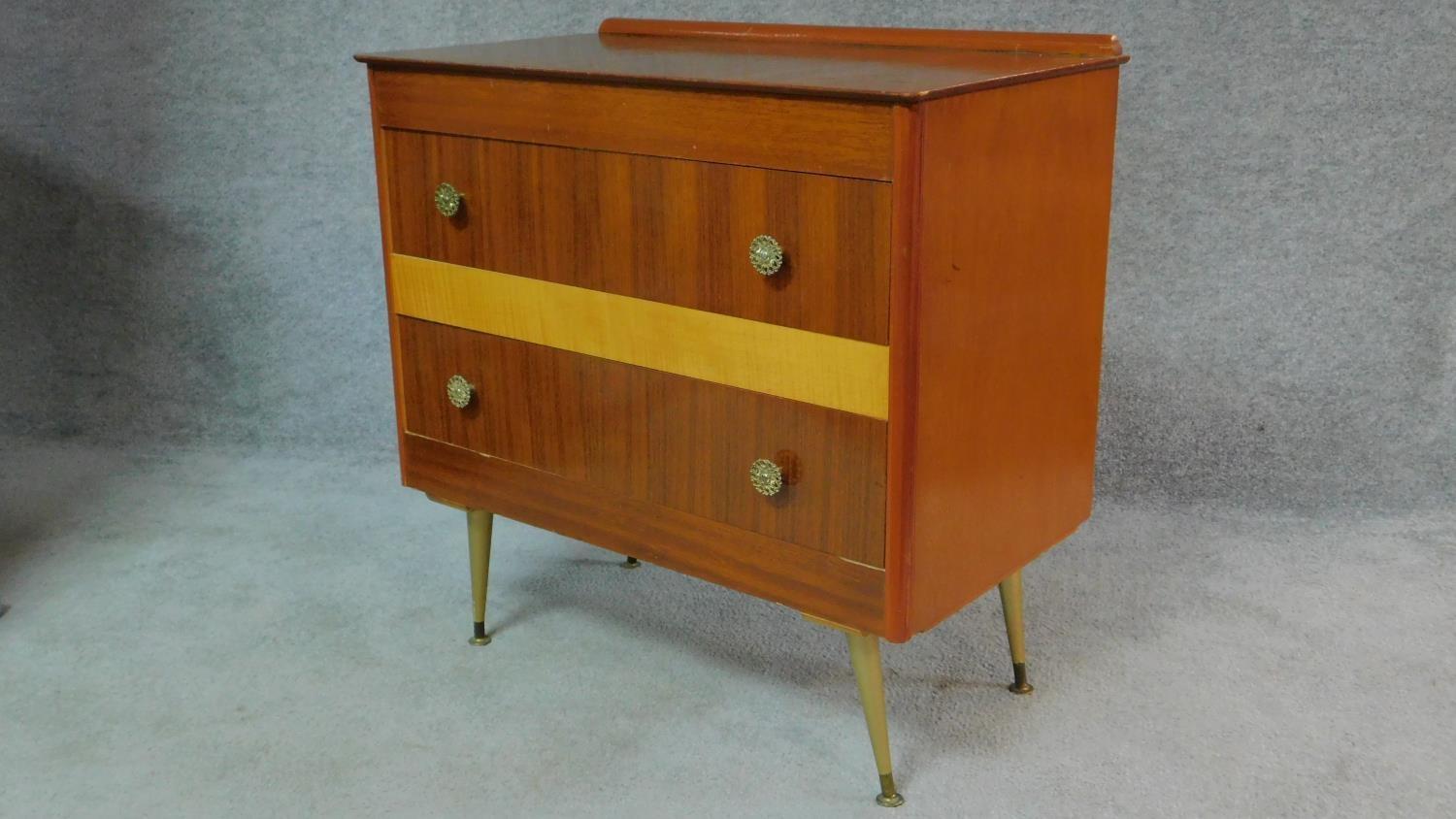 A vintage 1960's teak and satin birch inlaid chest of two long drawers on sputnik style supports. - Image 2 of 6
