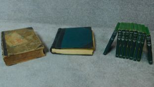 A collection of popular books in covers, an old leather bound book, 'P.F. Joannis A Jesu. Maria.