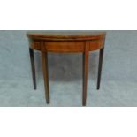 A Georgian mahogany and boxwood strung demi lune card table on square tapering supports. H.74 W.91