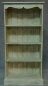 A distressed painted open bookcase on plinth base. H.121 W.60 D.22cm
