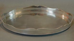 A large oval silver plated tray with wavy pierced gallery. 62x39cm