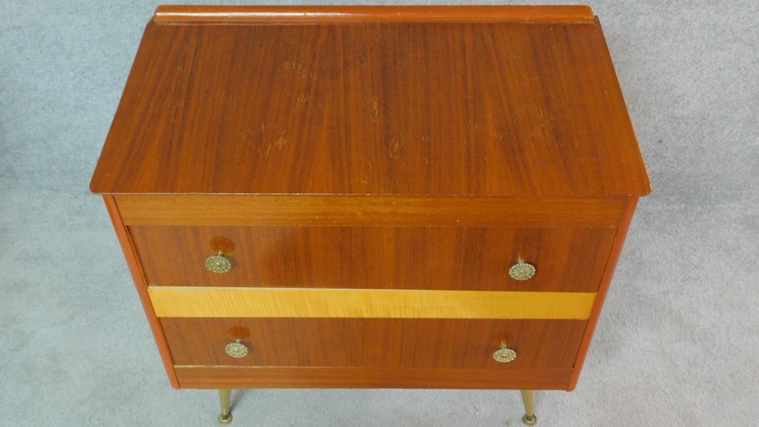 A vintage 1960's teak and satin birch inlaid chest of two long drawers on sputnik style supports. - Image 4 of 6