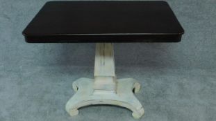 An early 19th century distressed painted table with polished tilt top on platform base. H.72 W.91