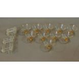 A set of ten vintage champagne bowls and a set of glass knife rests.