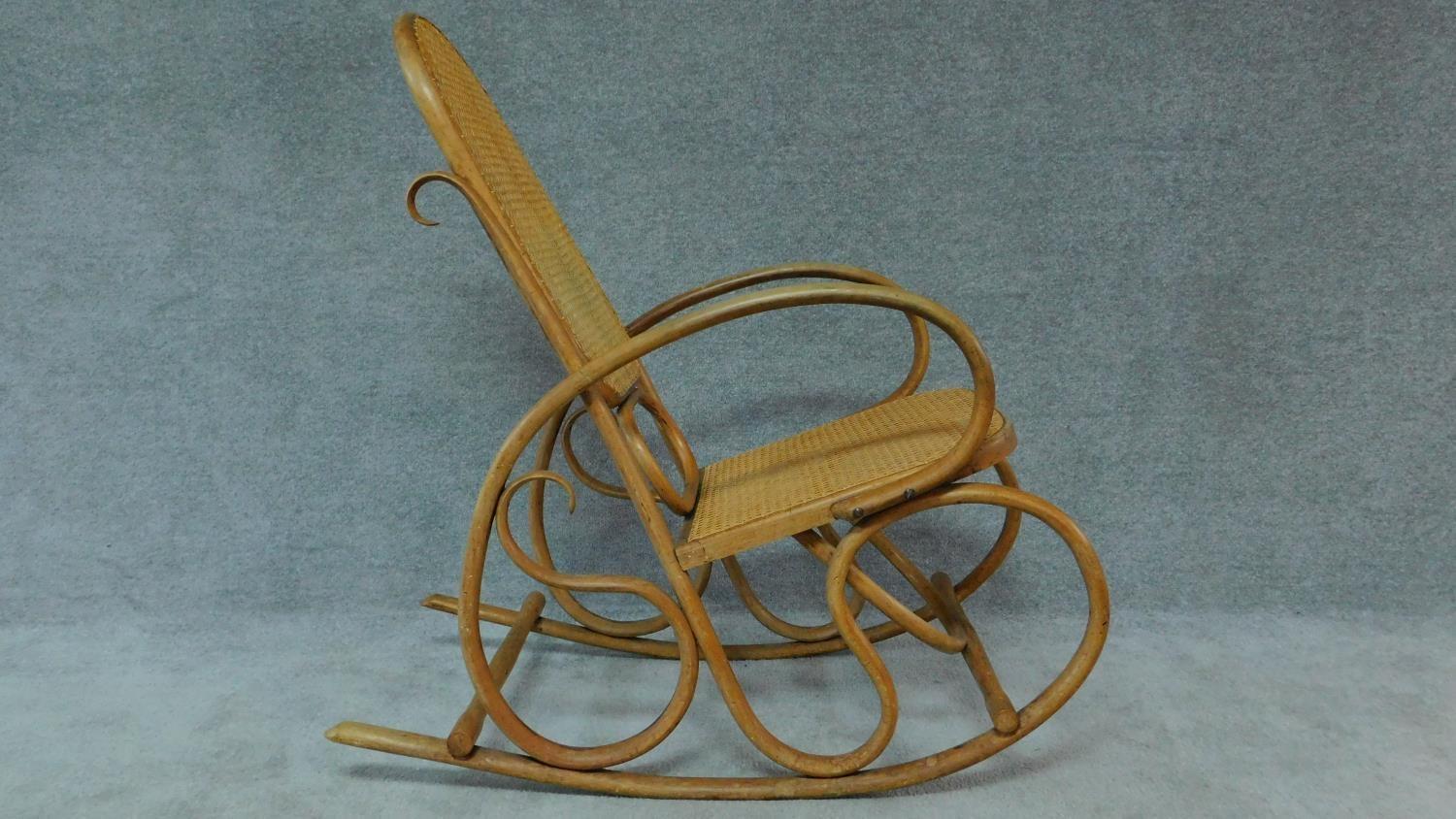 A Thonet style bentwood rocking armchair with caned back and seat. H.97cm - Image 3 of 4