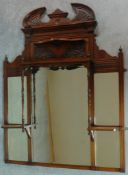 A Victorian carved walnut overmantel with broken arch pediment. H.135 W.111 D.16cm