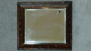 An 18th century floral inlaid cushion mirror with bevelled plate. 66x58cm