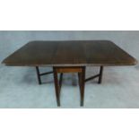 A mahogany drop flap dining table on square stretchered supports. H.77 W.175 D.121cm