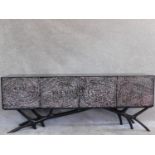 A contemporary four door lacquered sideboard on naturalistic base. H.77 W.200 D.40cm