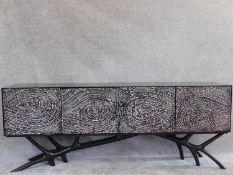 A contemporary four door lacquered sideboard on naturalistic base. H.77 W.200 D.40cm