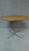 A circular Danish teak Fritzhansen centre table on metal quadruped supports,