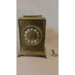A late 19th century brass cased mantel clock H.23 W.17cm (with key and pendulum)