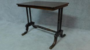 A Regency rosewood centre table on stretchered bobbin turned supports on swept feet terminating in