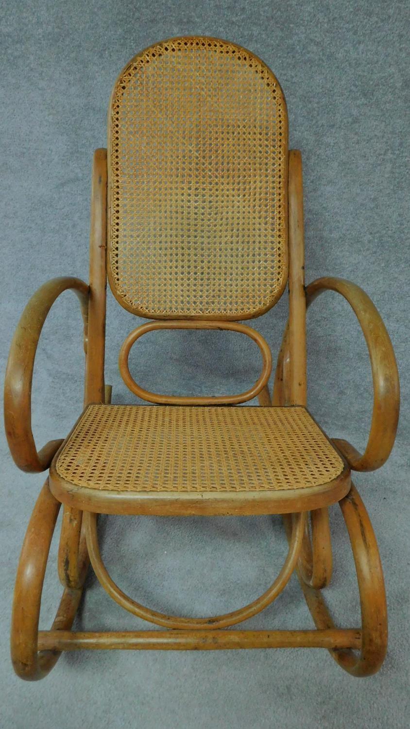 A Thonet style bentwood rocking armchair with caned back and seat. H.97cm - Image 2 of 4
