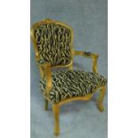 A gilt framed French style fauteuil in leopard print upholstery. H.94cm