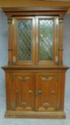 A 19th century Flemish oak two section bookcase the upper section fitted leaded coloured glass doors