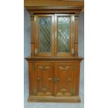 A 19th century Flemish oak two section bookcase the upper section fitted leaded coloured glass doors