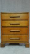 A mid 20th century Art Deco style oak chest of four long drawers on carved bracket feet. H.95 W.75